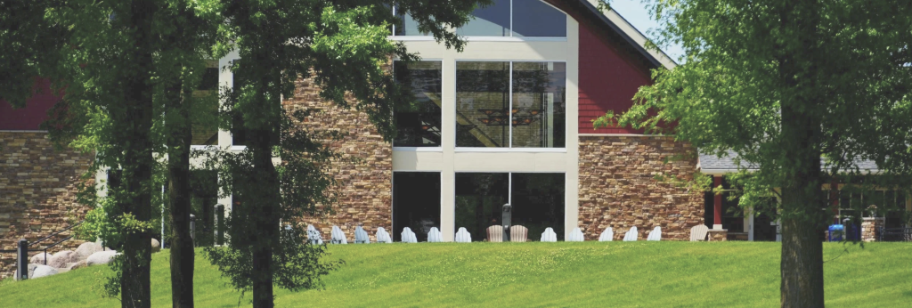 Exterior view of Honey Creek Resort on Rathbun Lake with outdoor chairs
